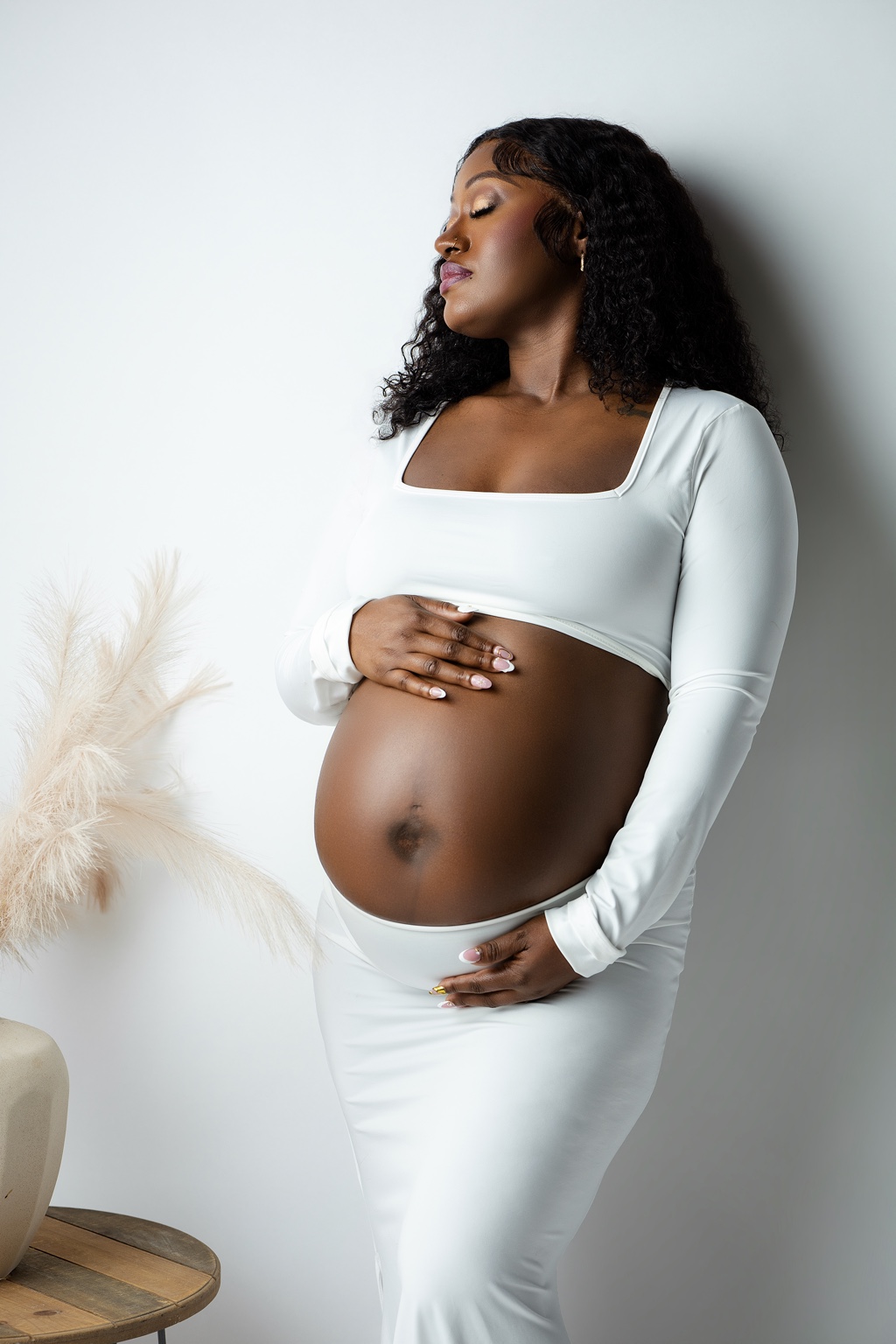 Expecting mother in a white studio outfit