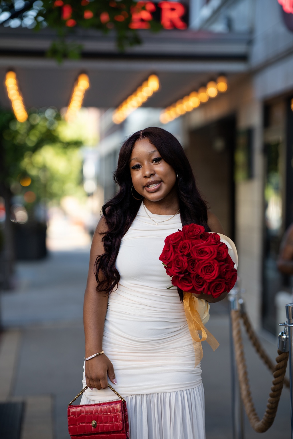Outdoor portrait with a bouquet of red roses