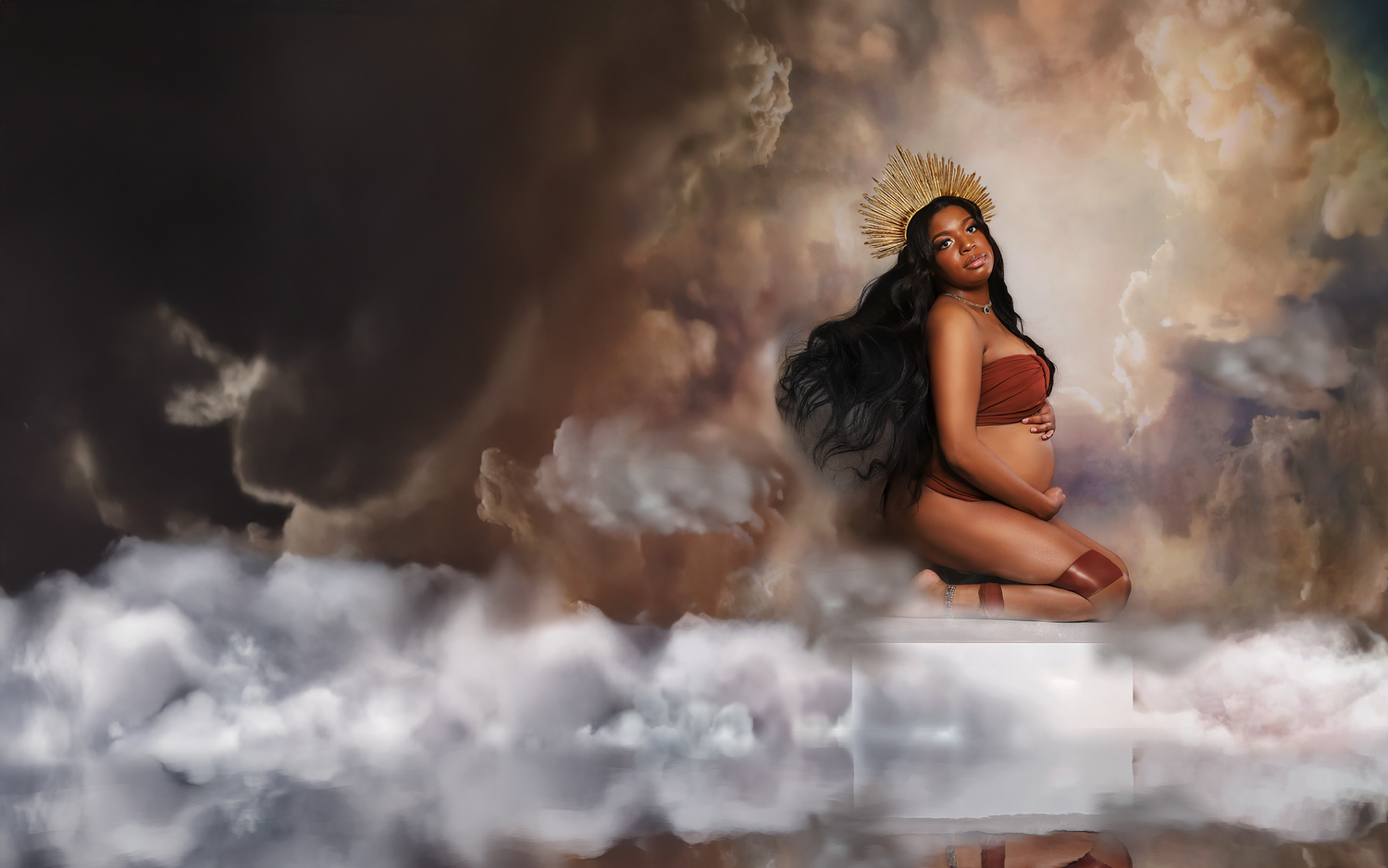 Fine art maternity portrait amid clouds