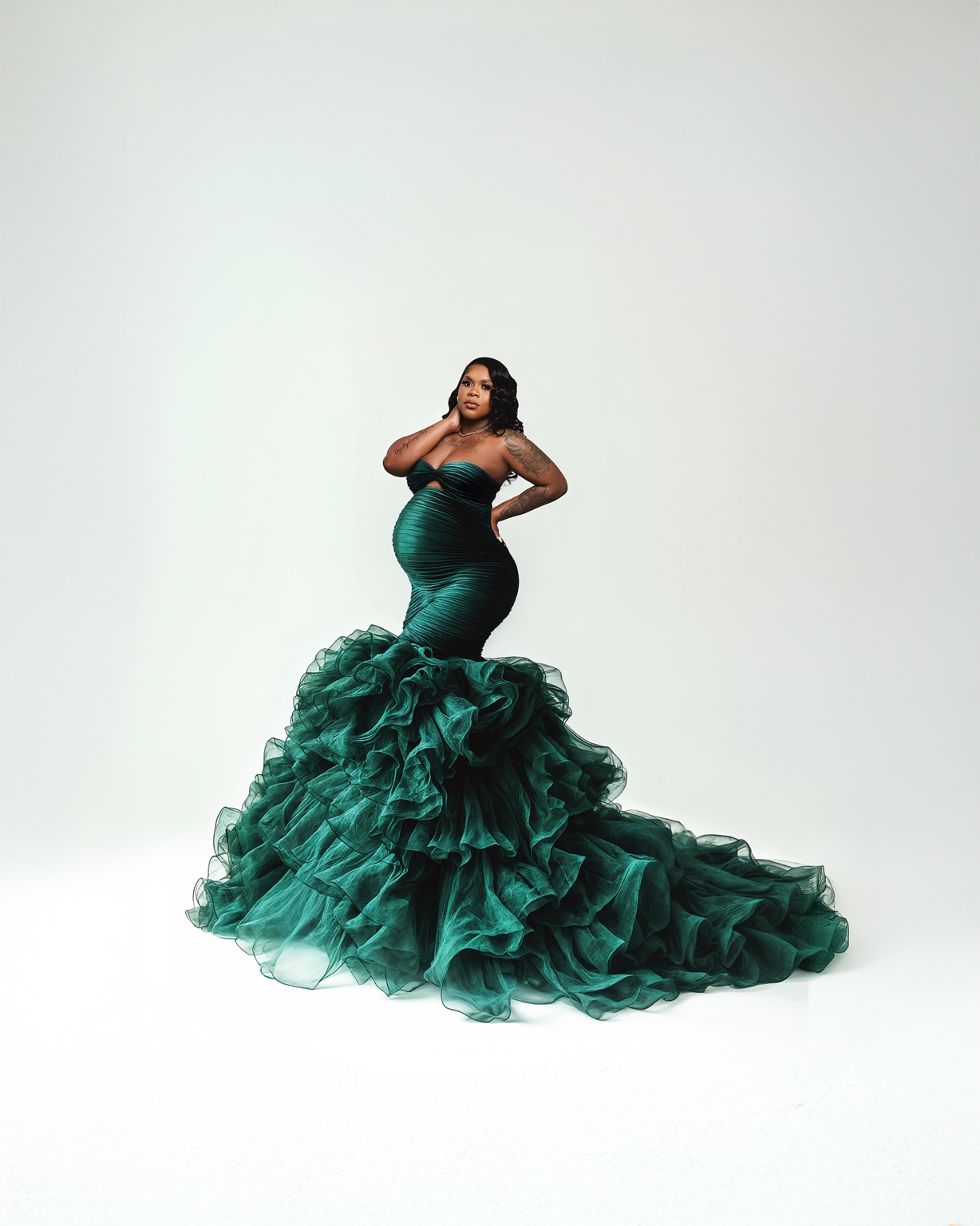 Expecting mother in a dramatic emerald green gown