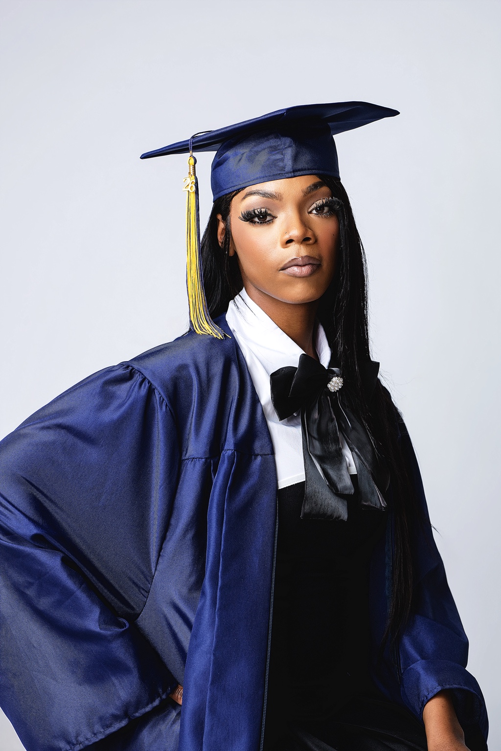 Graduation studio portrait in a navy cap and gown