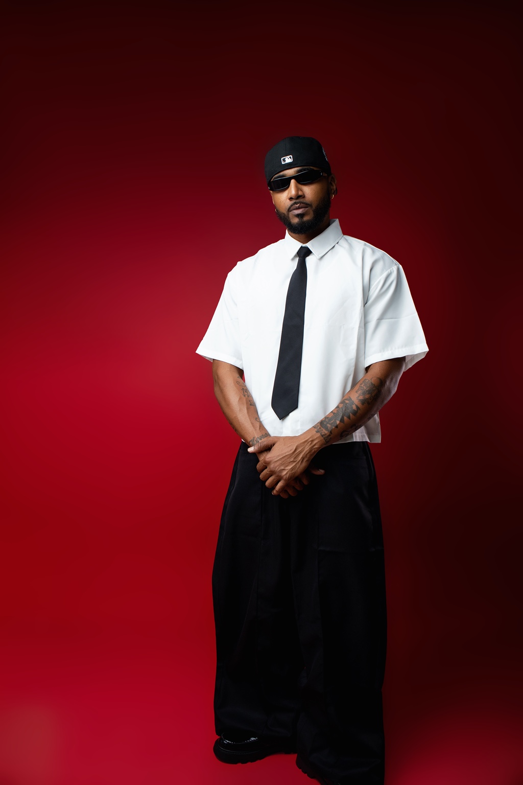 Men's fashion portrait against a rich red studio backdrop